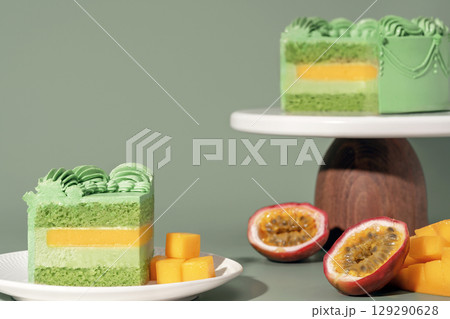 Vibrant bento cake featuring layers of mango and passion fruit, adorned with pistachio sponge, presented on elegant stands, showcasing a delightful dessert and pastry menu concept Vibrant bento cake featuring layers of mango and passion fruit, adorned with pistachio sponge, presented on elegant stands, showcasing a delightful dessert and pastry menu concept 129290628