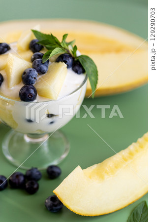 Nutritious protein snack yogurt with blueberries and melon cubes 129290703