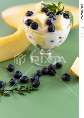 Elegant dessert in a glass yogurt melon blueberries and mint Elegant dessert in a glass yogurt melon blueberries and mint 129290704