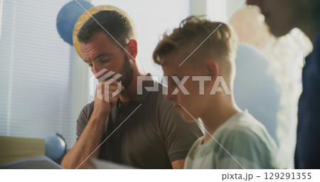 Parents Looking at School Exam Grades of Their Son, Upset About Poor School Performance 129291355