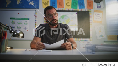 Male Teacher Discussing Low Academic Grades of Primary School Student with His Mother Male Teacher Discussing Low Academic Grades of Primary School Student with His Mother 129291418