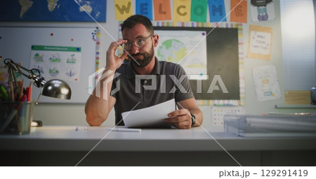 Male Teacher Discussing Low Academic Grades of Primary School Student with His Mother Male Teacher Discussing Low Academic Grades of Primary School Student with His Mother 129291419