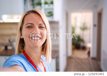 Smiling female doctor taking selfie at hospital 129291461