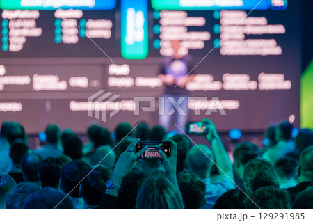 Audience capturing a business presentation with smartphones during a conference 129291985