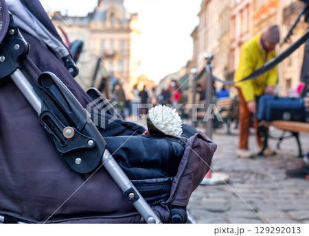 Baby carriage with bouquet of white flowers in Lviv, Ukraine Baby carriage with bouquet of white flowers in Lviv, Ukraine 129292013