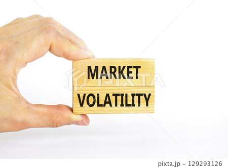Market volatility symbol. Concept words Market volatility on beautiful wooden blocks. Beautiful white table white background. Businessman hand. Business market volatility concept. Copy space. Market volatility symbol. Concept words Market volatility on beautiful wooden blocks. Beautiful white table white background. Businessman hand. Business market volatility concept. Copy space. 129293126