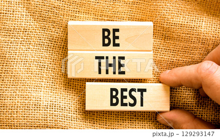 Motivational be the best symbol. Concept words Be the best on beautiful wooden blocks. Beautiful canvas background. Businessman hand. Business motivational be the best concept. Copy space. 129293147
