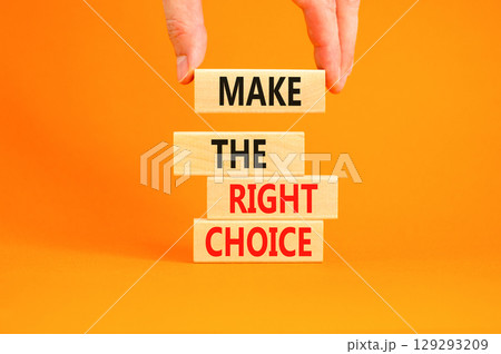 Make the right choice symbol. Concept words phrase Make the right choice on beautiful wooden blocks. Beautiful orange background. Businessman's hand. Business Make the right choice concept. Copy space Make the right choice symbol. Concept words phrase Make the right choice on beautiful wooden blocks. Beautiful orange background. Businessman's hand. Business Make the right choice concept. Copy space 129293209