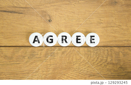Agree symbol. Concept word Agree on beautiful white pills circles. Beautiful wooden table wooden background. Business agree concept. Copy space. 129293245