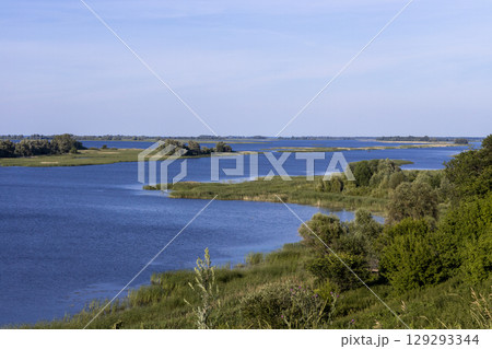 Russian landscape with Volga river on a sunny day. Bolgar, Tatarstan, Russia. View on the valley of Volga river from the hill. Peaceful nature. Beautiful background. Russian landscape with Volga river on a sunny day. Bolgar, Tatarstan, Russia. View on the valley of Volga river from the hill. Peaceful nature. Beautiful background. 129293344