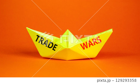 Trade wars symbol. Concept word Trade wars on beautiful yellow paper boat. Beautiful orange paper background. Business trade wars concept. Copy space. Trade wars symbol. Concept word Trade wars on beautiful yellow paper boat. Beautiful orange paper background. Business trade wars concept. Copy space. 129293358