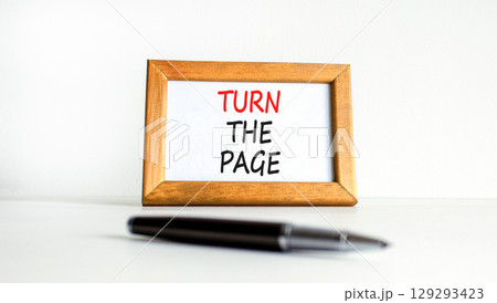 Turn the page symbol. Concept words Turn the page on beautiful wooden picture frame. Black pen. Beautiful white background. Business motivational lifestyle turn the page concept. Copy space. 129293423