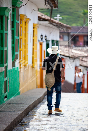 Local man wearing a traditional hat walking at the beautiful streets of the colonial town of Concepcion in Antioquia, Colombia. 129293451
