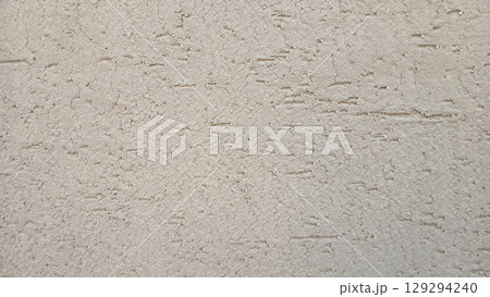Close-Up of Rough Textured Plastered Wall in Neutral Beige Tone 129294240