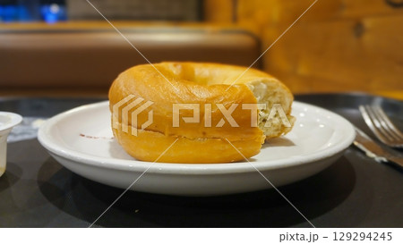 Freshly Baked Bagel Served on a White Plate Freshly Baked Bagel Served on a White Plate 129294245
