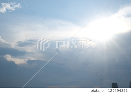 Sky blue and orange light of the sun through the clouds in the sky Sky blue and orange light of the sun through the clouds in the sky 129294821