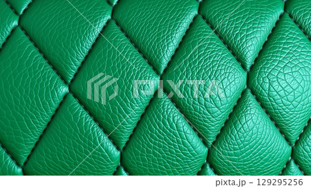 Green artificial leather surface texture, stitched in the form of rhombuses, squares, rectangles. Quilted eco-leather.  129295256