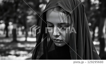 Portrait of a Woman in a Black Mourning Veil on Her Head 129295680