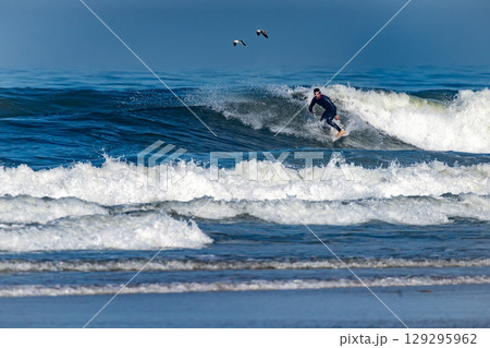 Surfer riding waves in Furadouro Beach Surfer riding waves in Furadouro Beach 129295962