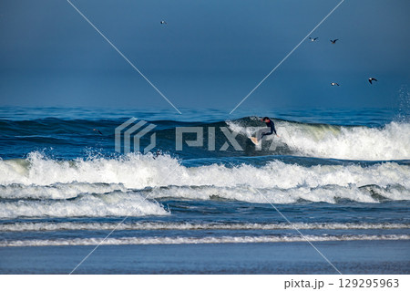 Surfer riding waves in Furadouro Beach Surfer riding waves in Furadouro Beach 129295963