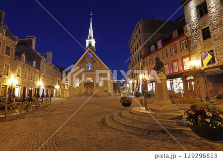 Tourists enjoying walking in Old Quebec streets, including Quebecois Fresco and Notre Dame des Victories church in Place Royale 129296813