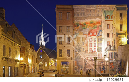 Tourists enjoying walking in Old Quebec streets, including Quebecois Fresco and Notre Dame des Victories church in Place Royale 129296814