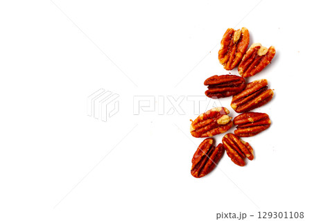 Delicious salted pecan nuts scattered. Delicious salted pecan nuts scattered. 129301108