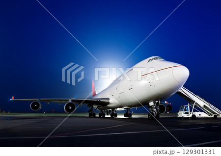 The plane stands at the airport at night 129301331