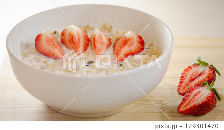 Granola with Milk and Sliced Strawberries for Breakfast Granola with Milk and Sliced Strawberries for Breakfast 129301470