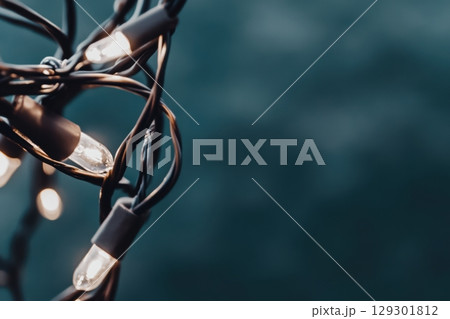 Warm glow from string lights creates a cozy atmosphere in the evening 129301812