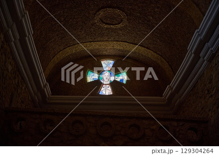 Stained Glass Cross with Religious Symbolism in Stone Interior Stained Glass Cross with Religious Symbolism in Stone Interior 129304264