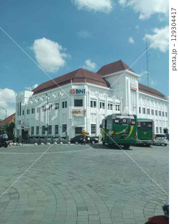 BNI 1946 Building, Yogyakarta. Exterior photograph of the Bank Negara Indonesia (BNI) building, a historic heritage site at Kilometer Zero point. This classic Art Deco-style building is a prominent la BNI 1946 Building, Yogyakarta. Exterior photograph of the Bank Negara Indonesia (BNI) building, a historic heritage site at Kilometer Zero point. This classic Art Deco-style building is a prominent la 129304417