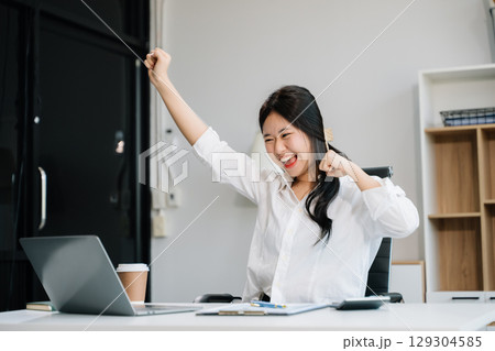 business woman are delighted and happy with the work they do on their tablet, laptop 129304585