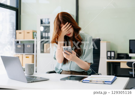Asian business woman is stressed, bored, and overthinking from working Asian business woman is stressed, bored, and overthinking from working 129305116