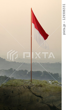 Closeup view of the Indonesian national flag waving against a sky background. Celebrate Indonesia Independence Day. Concept of Kemerdekaan Indonesia 129306331