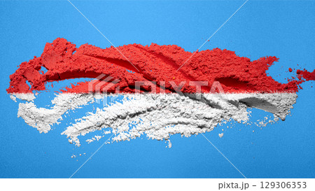 Closeup view of the red and white colors of the Indonesian national flag with a blue wall background. Celebrate Indonesia Independence Day. Concept of Kemerdekaan Indonesia 129306353