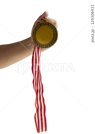 Human hand holding golden award medal suspended from a red and white striped ribbon isolated over a white background. Copy space. Symbol of achievement, recognition, or competition Human hand holding golden award medal suspended from a red and white striped ribbon isolated over a white background. Copy space. Symbol of achievement, recognition, or competition 129306431