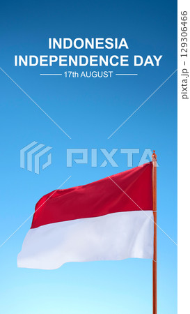 Message of Indonesia Independence Day on 17th August with an Indonesian national flag on a blue sky background. Celebrate Indonesia Independence Day. Concept of Kemerdekaan Indonesia 129306466