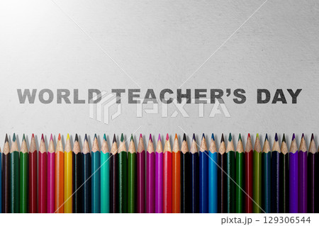 Row of colored pencils with the message of World Teacher Day on a grey background. Concept of World Teacher Day 129306544