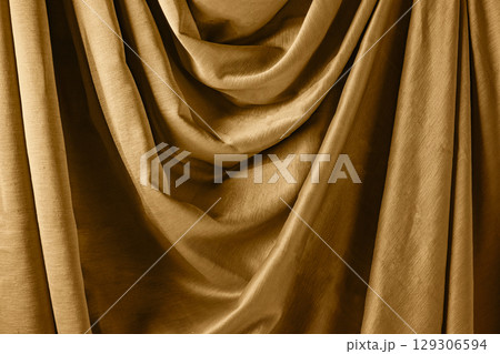 Golden satin silk with crumpled abstract texture background. Material textile surface. Copy space Golden satin silk with crumpled abstract texture background. Material textile surface. Copy space 129306594