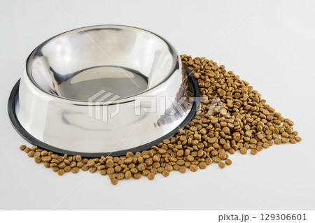 Dog and cat dry food on a stainless steel bowl on a white background 129306601