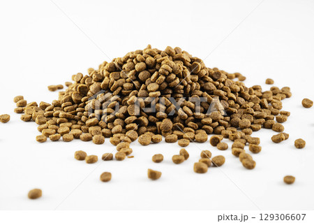 Dog and cat dry food splattered isolated over a white background Dog and cat dry food splattered isolated over a white background 129306607