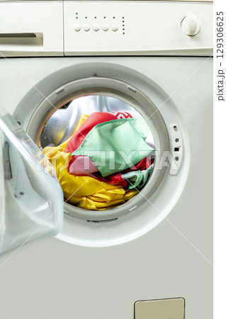 Shirt and clothes in the washing machine drum. Home appliance Shirt and clothes in the washing machine drum. Home appliance 129306625