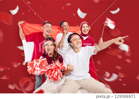 Indonesian southeast asian people celebrate Indonesia Independence Day on the 17th of August by holding the Indonesian national flag. Concept of Kemerdekaan Indonesia Indonesian southeast asian people celebrate Indonesia Independence Day on the 17th of August by holding the Indonesian national flag. Concept of Kemerdekaan Indonesia 129306971
