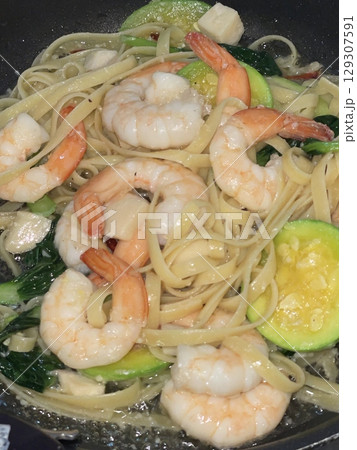 Gambas spaghetti with succulent shrimp, garlic, olive oil, and chili flakes a perfect fusion of seafood richness and Italian flavor in every bite. 129307591