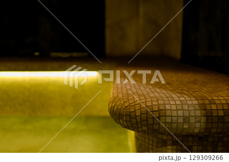 Interior of a hammam sauna with stone finishing and lighting 129309266