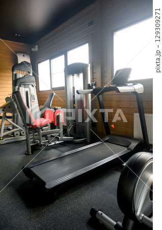 Small Modern gym with a variety of equipment Small Modern gym with a variety of equipment 129309271