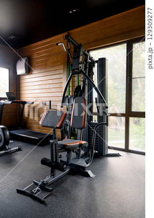 Small Modern gym with a variety of equipment Small Modern gym with a variety of equipment 129309277