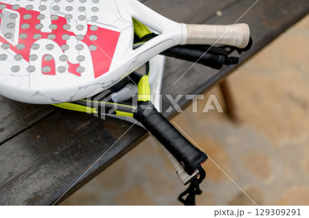 Paddle tennis rackets left on table, close up Paddle tennis rackets left on table, close up 129309291