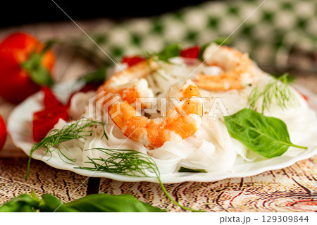 Asian lunch boiled rice noodles shrimp on a wooden table 129309844